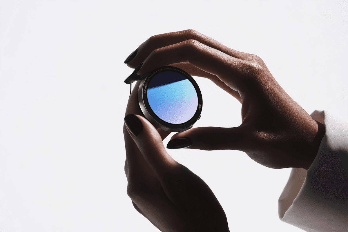 Hand holding a camera lens